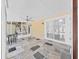 A sunroom offers natural light and a ceiling fan above a stone tile floor at 315 Wooten Rd, Lutz, FL 33548