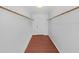 Walk-in closet with hardwood flooring, ample hanging space, and a neutral color palette at 315 Wooten Rd, Lutz, FL 33548