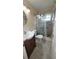 Modern bathroom featuring tiled floors, glass shower, and a dark wood vanity at 3436 100Th N Ave, Pinellas Park, FL 33782