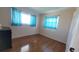 Bright bedroom featuring hardwood floors and natural light from the two large windows at 3436 100Th N Ave, Pinellas Park, FL 33782
