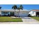 Charming single-story home with a well-maintained lawn, palm trees and brick-paved driveway at 3436 100Th N Ave, Pinellas Park, FL 33782
