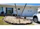 A well-maintained front yard featuring decorative stone accents and lush greenery at 3436 100Th N Ave, Pinellas Park, FL 33782