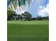 Picturesque view of the Mainlands golf course showcasing pristine greens and mature trees at 3436 100Th N Ave, Pinellas Park, FL 33782