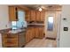 Functional kitchen featuring wooden cabinets, stainless steel dishwasher, and access to the outside at 3436 100Th N Ave, Pinellas Park, FL 33782