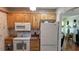 Kitchen featuring classic white appliances and wooden cabinetry at 3436 100Th N Ave, Pinellas Park, FL 33782
