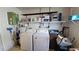 Functional laundry area with washer, dryer, shelving and utility storage at 3436 100Th N Ave, Pinellas Park, FL 33782