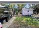 Expansive backyard features a storage shed, swing set, and outdoor cooking area at 37654 Eiland Blvd, Zephyrhills, FL 33542