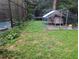 Fenced backyard featuring a chicken coop and adjacent enclosed pool area and trampoline at 37654 Eiland Blvd, Zephyrhills, FL 33542