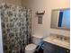 Bathroom showcasing a vanity with modern fixtures, a toilet, and a shower with curtain at 37654 Eiland Blvd, Zephyrhills, FL 33542