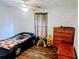 Bright bedroom featuring a unique car-shaped bed, wooden floors, and a ceiling fan at 37654 Eiland Blvd, Zephyrhills, FL 33542