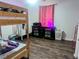 bedroom featuring a bunk bed, colorful dresser, and wood-look floors at 37654 Eiland Blvd, Zephyrhills, FL 33542