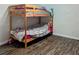 Bedroom featuring a bunk bed, wood-look floors, and neutral-colored walls at 37654 Eiland Blvd, Zephyrhills, FL 33542