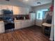 Updated kitchen featuring white cabinets, stainless steel appliances, and a window to the backyard at 37654 Eiland Blvd, Zephyrhills, FL 33542