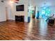 Spacious open-concept living room showing the dining room, wood floors, and neutral color palette at 37654 Eiland Blvd, Zephyrhills, FL 33542