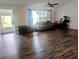Open living room with updated laminate flooring and lots of natural light at 37654 Eiland Blvd, Zephyrhills, FL 33542
