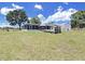 Large backyard featuring a screened-in porch, storage shed, and play area perfect for outdoor enjoyment at 3908 N Forbes Rd, Plant City, FL 33565