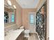 Stylish bathroom featuring a modern vanity, decorative tile, and walk out door at 3908 N Forbes Rd, Plant City, FL 33565