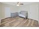 Neutral Bedroom featuring wood-style floors, grey dresser, and a ceiling fan at 3908 N Forbes Rd, Plant City, FL 33565