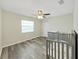 Bright bedroom features wood-look floors and ceiling fan for a cozy, comfortable space at 3908 N Forbes Rd, Plant City, FL 33565
