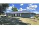Charming single-story home featuring a lush lawn, complemented by mature trees and a serene setting at 3908 N Forbes Rd, Plant City, FL 33565