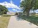 Single-story home with a long concrete driveway, providing ample parking space and curb appeal at 3908 N Forbes Rd, Plant City, FL 33565