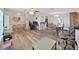 Open concept living room featuring wood floors, dining area, and comfortable furniture at 3908 N Forbes Rd, Plant City, FL 33565
