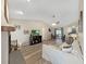 Open-concept living room featuring luxury vinyl floors, a ceiling fan, and lots of natural light at 3908 N Forbes Rd, Plant City, FL 33565