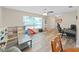 Bright living room with ceiling fan, wood flooring, and plenty of natural light at 3908 N Forbes Rd, Plant City, FL 33565