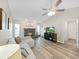 Inviting living room with a cozy fireplace, vaulted ceiling, and stylish wood-look floors at 3908 N Forbes Rd, Plant City, FL 33565