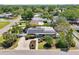 An aerial view of a home with solar panels, manicured landscaping, and a paved driveway at 4091 Cherry Ne St, St Petersburg, FL 33703