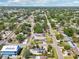 This high-angle aerial captures the property's location in a lush neighborhood with mature trees and residential streets at 4091 Cherry Ne St, St Petersburg, FL 33703