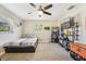 This bedroom features a ceiling fan, neutral walls, and a full-sized bed next to shelving for storage at 4091 Cherry Ne St, St Petersburg, FL 33703