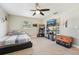This bedroom features a ceiling fan, neutral walls, and a full-sized bed next to shelving for storage at 4091 Cherry Ne St, St Petersburg, FL 33703
