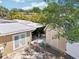 View of the home's exterior featuring a shed and a grill on a concrete patio at 4091 Cherry Ne St, St Petersburg, FL 33703