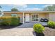 Close-up of the home's front entrance with a brick walkway, a dark front door, and attractive landscaping at 4091 Cherry Ne St, St Petersburg, FL 33703