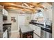 Bright kitchen with white cabinets, stainless steel appliances, and wooden beam ceiling at 4091 Cherry Ne St, St Petersburg, FL 33703