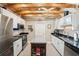 Bright kitchen with white cabinets, stainless steel appliances, and wooden beam ceiling at 4091 Cherry Ne St, St Petersburg, FL 33703
