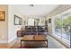 Comfortable living room with hardwood floors, a leather sofa, and a sliding barn door at 4091 Cherry Ne St, St Petersburg, FL 33703