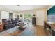 Cozy living room with a leather sofa, a large window, hardwood floors, and a stylish coffee table at 4091 Cherry Ne St, St Petersburg, FL 33703