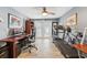 Dual-purpose office space featuring wood-look tile, a home gym with a bike and treadmill, and a workspace at 4091 Cherry Ne St, St Petersburg, FL 33703