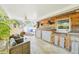 Entertainer's delight: outdoor bar with wood accents, seating, and a barbecue grill for summer fun at 4091 Cherry Ne St, St Petersburg, FL 33703