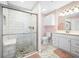 Bright bathroom featuring a glass enclosed shower, modern vanity, and marble floors for a luxurious feel at 4212 Fairway Cir, Tampa, FL 33618