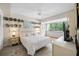 Comfortable bedroom featuring a queen-size bed, ceiling fan, and a large window offering natural light and outdoor views at 4212 Fairway Cir, Tampa, FL 33618