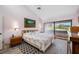 Comfortable bedroom with a floral bedspread, ceiling fan, and sliding door to a balcony at 4212 Fairway Cir, Tampa, FL 33618