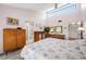 Bright bedroom with a floral comforter, ensuite bathroom, and plenty of storage at 4212 Fairway Cir, Tampa, FL 33618