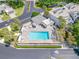 Aerial view of a refreshing community pool surrounded by manicured landscaping and a nearby community area at 4212 Fairway Cir, Tampa, FL 33618