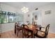 Bright dining room featuring a modern chandelier, a large window, and comfortable seating at 4212 Fairway Cir, Tampa, FL 33618