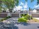 Charming townhome exterior featuring a two-car garage, well-maintained landscaping, and a spacious driveway at 4212 Fairway Cir, Tampa, FL 33618