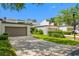 Charming townhome exterior featuring a two-car garage, well-maintained landscaping, and a spacious driveway at 4212 Fairway Cir, Tampa, FL 33618