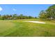 Scenic view of a lush golf course with a sand trap on a sunny day at 4212 Fairway Cir, Tampa, FL 33618